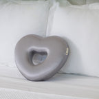 Longevity Pillow gray pillow on a white couch