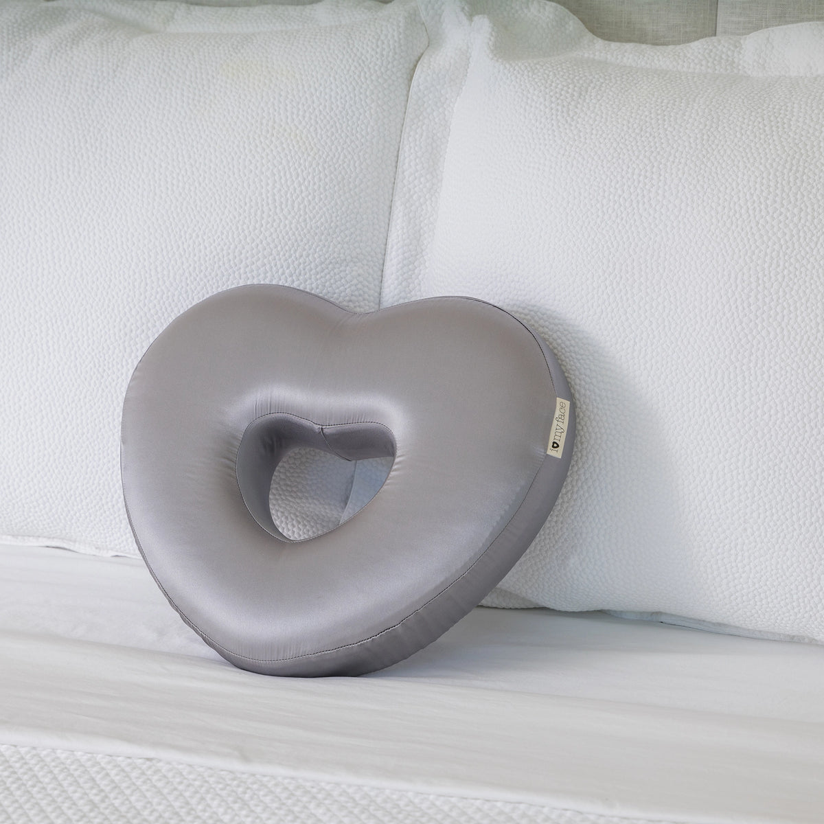 Longevity Pillow gray pillow on a white couch